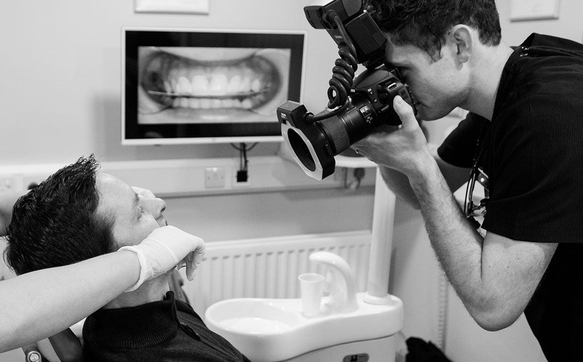 Atuart Black taking an enhanced photo of a patient's smile